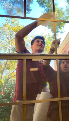 Students clean window during SET Week